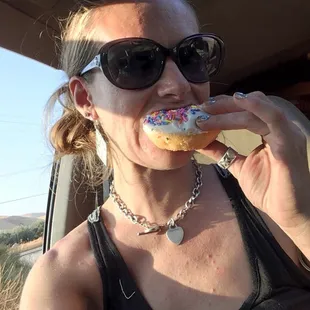 a woman eating a donut