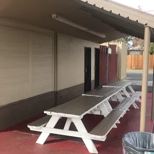 a picnic table and trash can