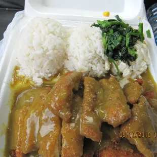 a tray of food with rice and meat