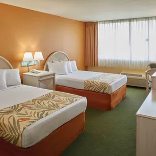 Two double beds, refrigerator, microwave, iron and ironing board.