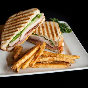 STEAKHOUSE CLUB Sliced turkey breast, ham, smoked bacon, American and Swiss cheese, lettuce, tomato, honey mustard