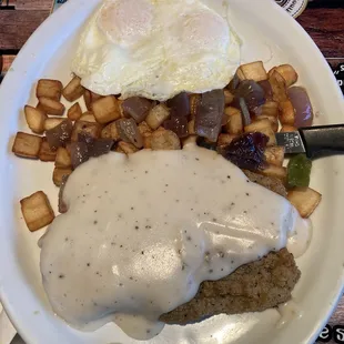 Chicken, fried steak, eggs, and home fries