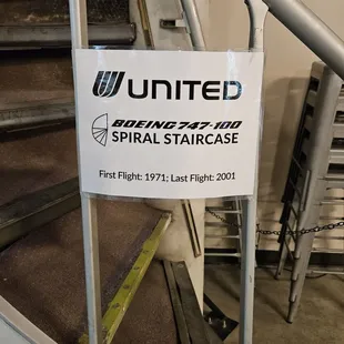 a sign on the stairs of an airplane