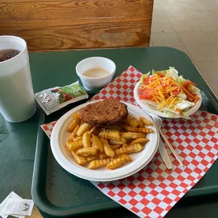 Chicken Fried Steak with French Fries and salad.