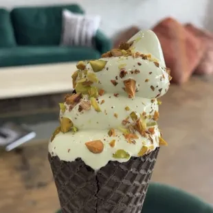 an ice cream cone with pistachios and nuts