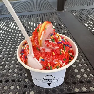 Strawberry mango swirl with sprinkles and strawberry syrup