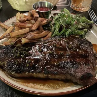Pomme frites. Bone in strip steak