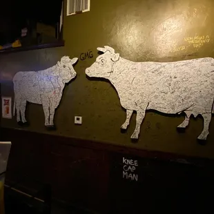 a cow and a cow on a wall