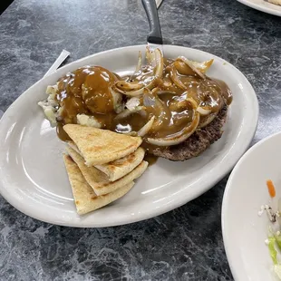 Hamburger steak with mashed potatoes and gravy.