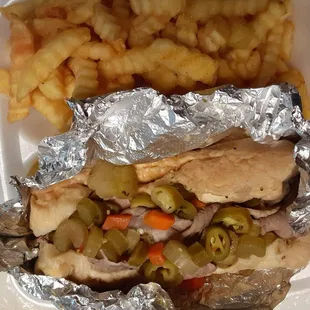 Italian beef with cheese, peppers and dipped with fries