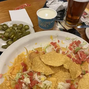 Went to moes next door to buy cheese for our nachos when server refused to add more cheese to a cheese less bottom layer