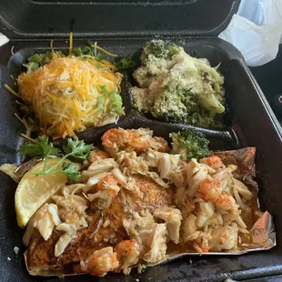 Grilled salmon topped with crab meat and shrimps, cheesy potatoes and broccoli