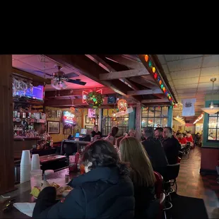 people sitting at tables in a restaurant