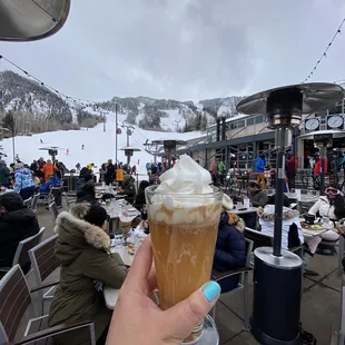 a person holding a drink in their hand