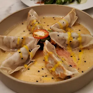 Potstickers: lemongrass chicken, aji amarillo, ginger citrus miso sauce ($18)