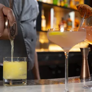a bartender pouring a drink
