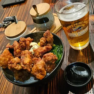 a bowl of fried chicken and a glass of beer