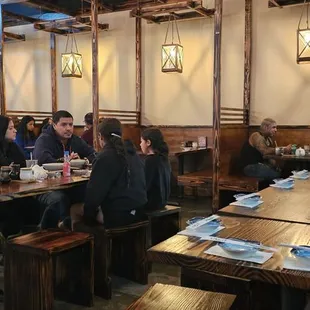 people sitting at tables in a restaurant