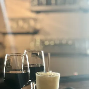 two glasses of wine and a drink