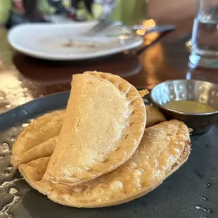 a plate of empanadas on a table
