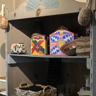 a shelf with plates and bowls on it