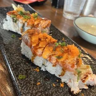 a sushi roll on a black plate