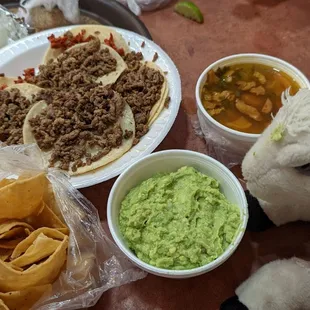 a stuffed animal sitting next to a plate of food