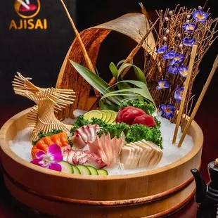 a wooden bowl of sushi and vegetables