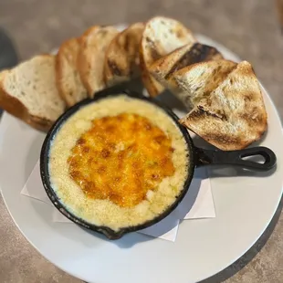 a plate of food with bread and dip