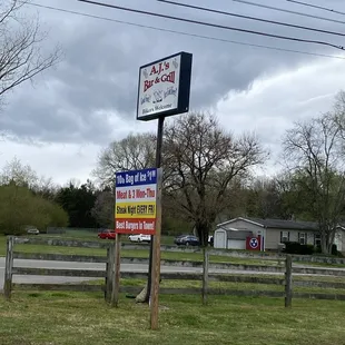 a sign for aj&apos;s bar &amp; grill