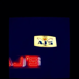 the neon sign for aj's