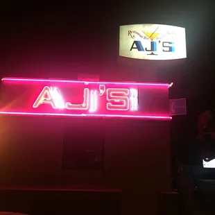 the neon sign for aj's