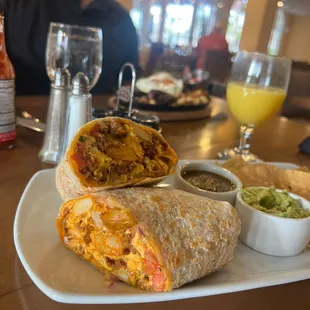 a burrito with a side of guacamole