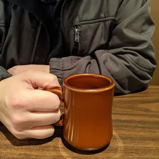 a man holding a coffee mug