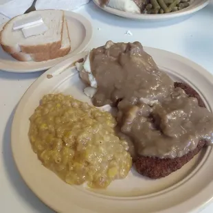 Lunch special: Fried pork cutlet, mashed potatoes, and creamed corn and white bread