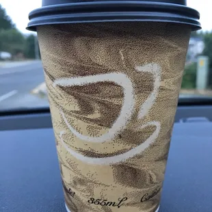 a coffee cup on a car dashboard