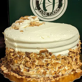 a cake with white frosting and toasted almonds