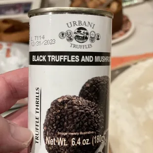 a can of black truffles and muffins