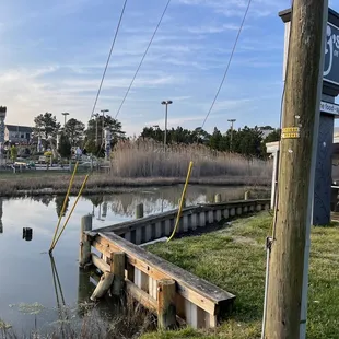 a wooden dock with a sign on it