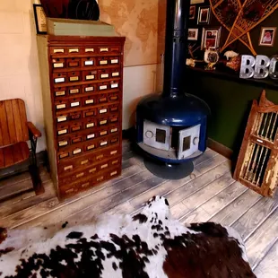 ows a cow hide rug and a wood burning stove