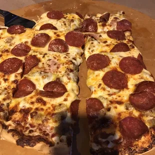 a pepperoni pizza cut in half