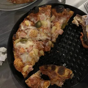 a pizza with olives and cheese