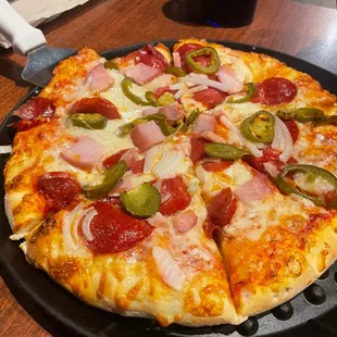 Custom pizza with pepperoni, onion. jalapeño, and Canadian bacon.