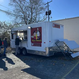 a food truck parked on the side of the road