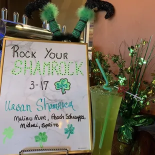 a green drink and a sign that says rock your shamrock