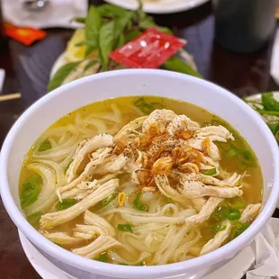 a bowl of chicken noodle on a table