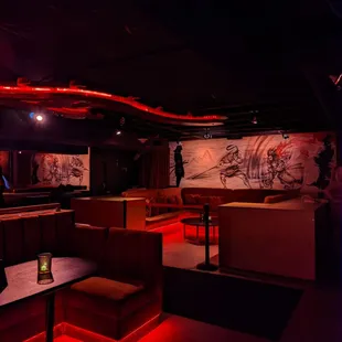 a dimly lit bar with red lighting