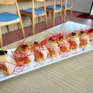 Arcadia Roll: spicy tuna, cucumber in, wrapped in soy paper and seared yellowtail, jalapeño, sauces &amp; unique chili threads on top! So good!