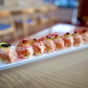 Arcadia Roll: spicy tuna, cucumber in, wrapped in soy paper and seared yellowtail, jalapeño, sauces &amp; unique chili threads on top! So good!