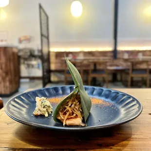 Gobo over salmon in banana leaf